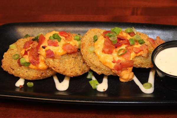 Our Fried Green Tomatoes are topped with pimento cheese